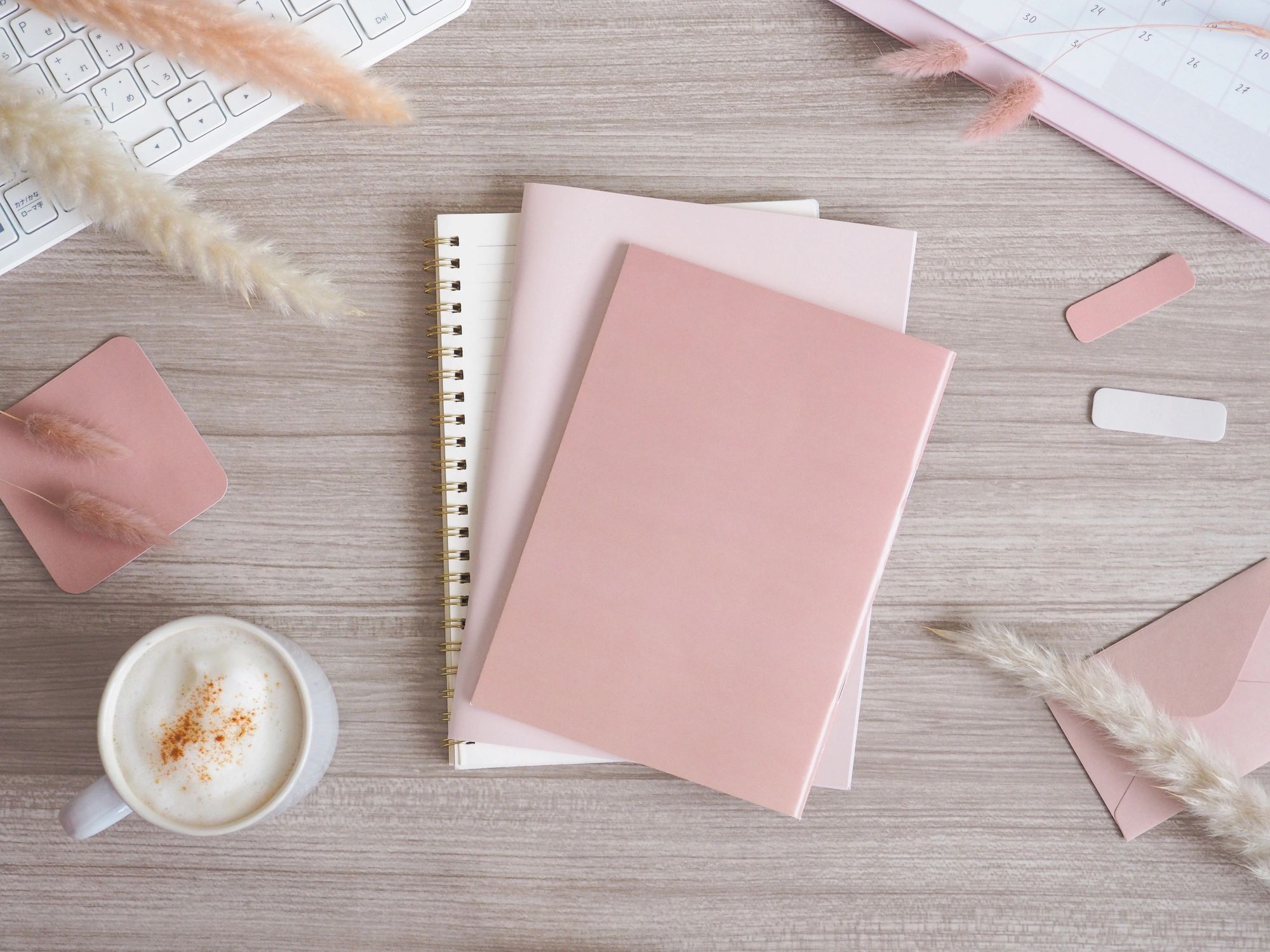 Planning desk flat lay with notebook and workspace items
