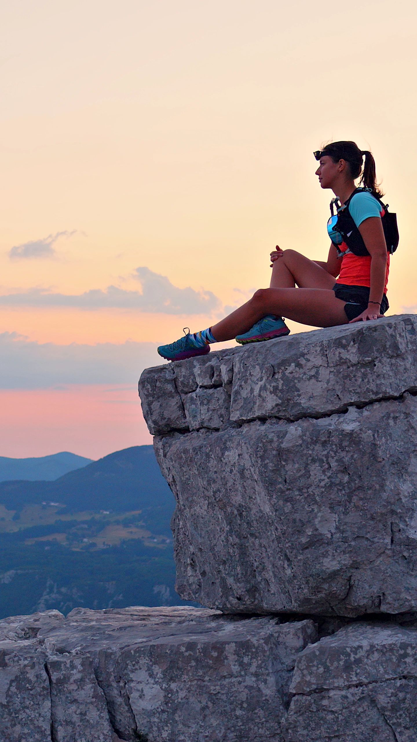 Person on a rocky peak at sunset—new perspective and confidence